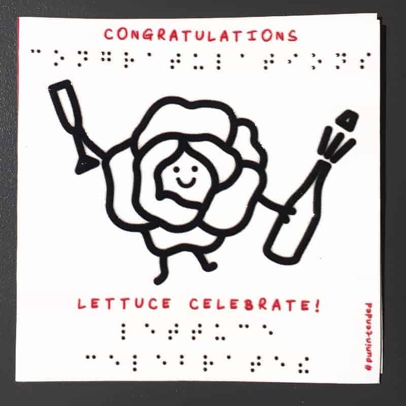 Congratulations tactile pun braille greeting cards showing a lettuce carrying a champagne bottle and glass, with a smiley face in between a lettuce