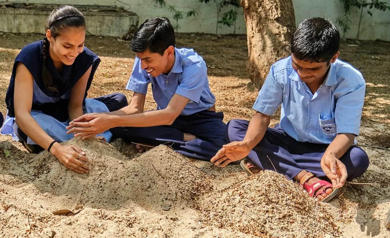 Visually impaired children laughing and playing on the school playground