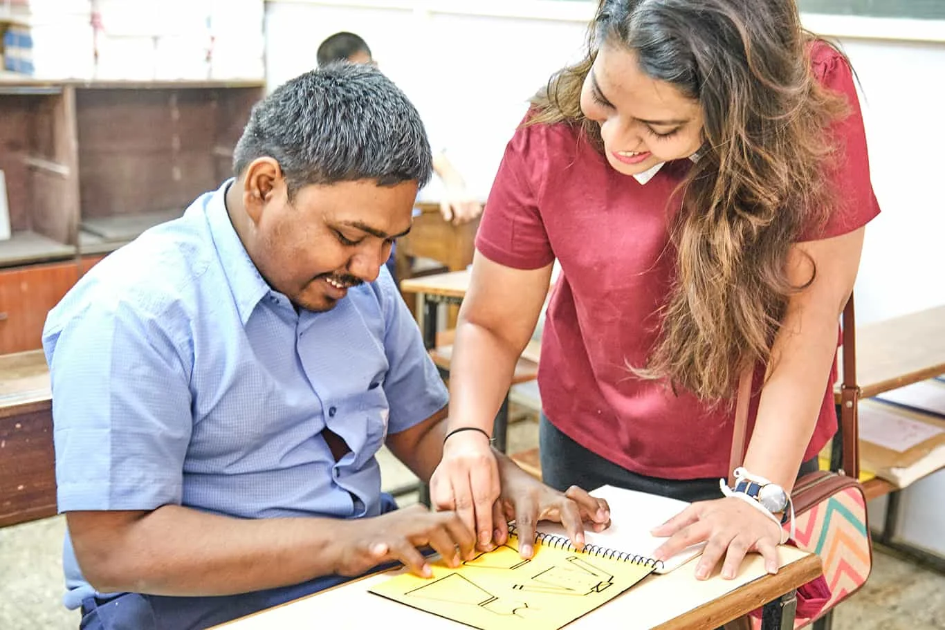 Beyond Braille founder Nupur Agarwal showing her tactile picture braille books to visually impaired students in surat city